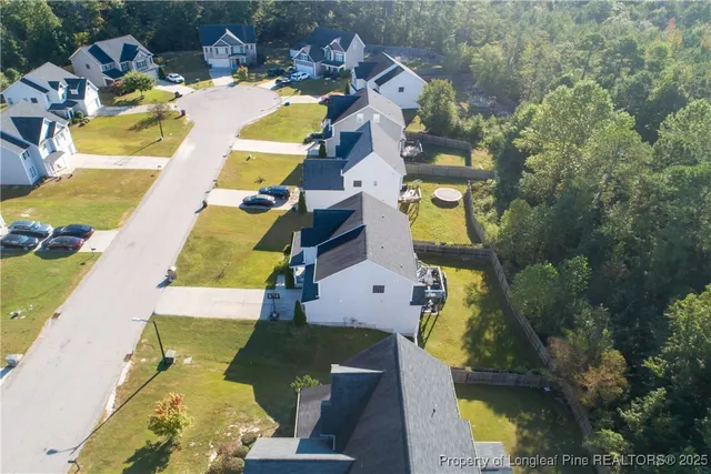 an aerial view of a swimming pool with outdoor seating