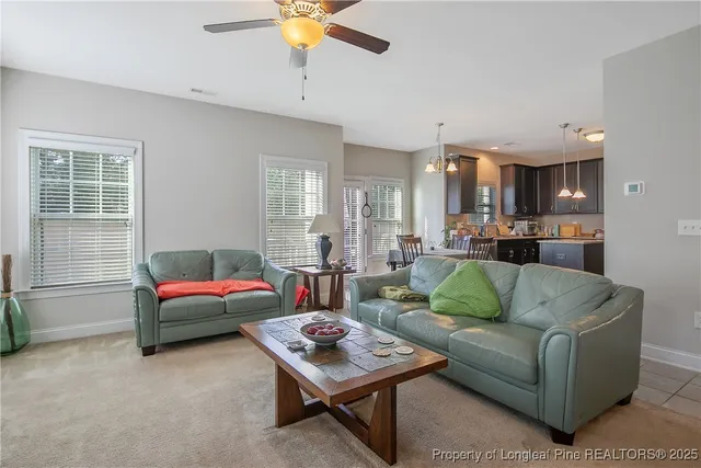 a living room with furniture and kitchen view