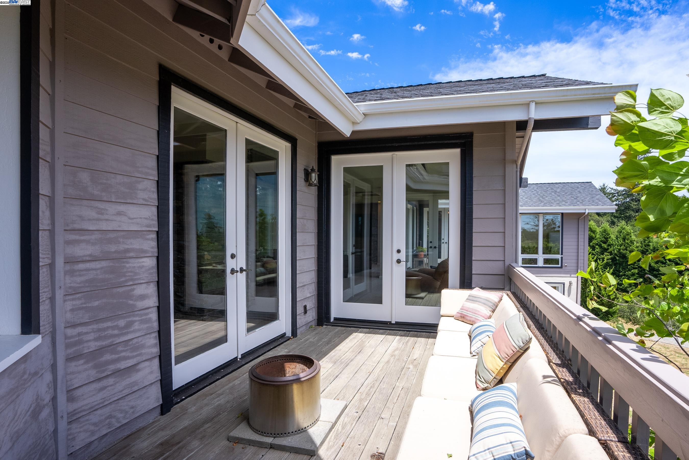 905 Moon Valley Ranch Road Watsonville, CA 95076 - Photo 21 of 60 a view of a patio with table and chairs and floor to ceiling window and potted plants