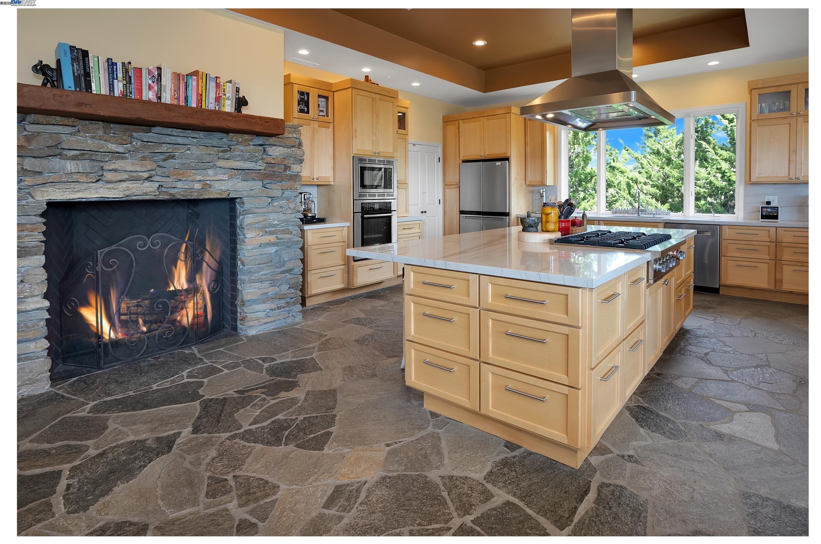 905 Moon Valley Ranch Road Watsonville, CA 95076 - Photo 28 of 60 a kitchen with stainless steel appliances granite countertop a stove a chimney and a fireplace