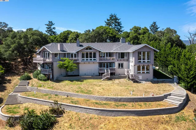 a view of a house with a sink and yard with swimming pool and patio