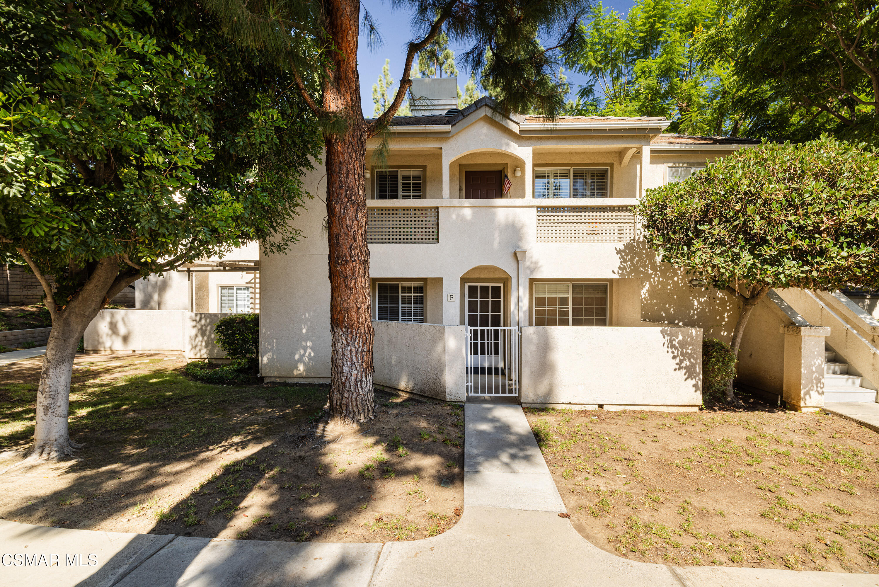 1125 Fitzgerald Road, Unit F Simi Valley, CA 93065 - Photo 1 of 25 a view of a white house with a yard and tree s