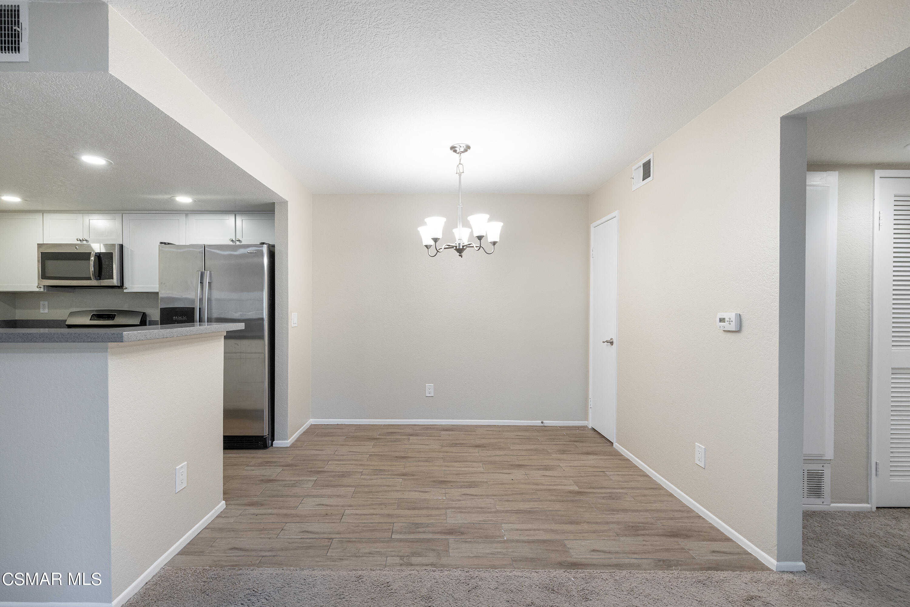1125 Fitzgerald Road, Unit F Simi Valley, CA 93065 - Photo 11 of 25 a view of kitchen with granite countertop cabinets and refrigerator