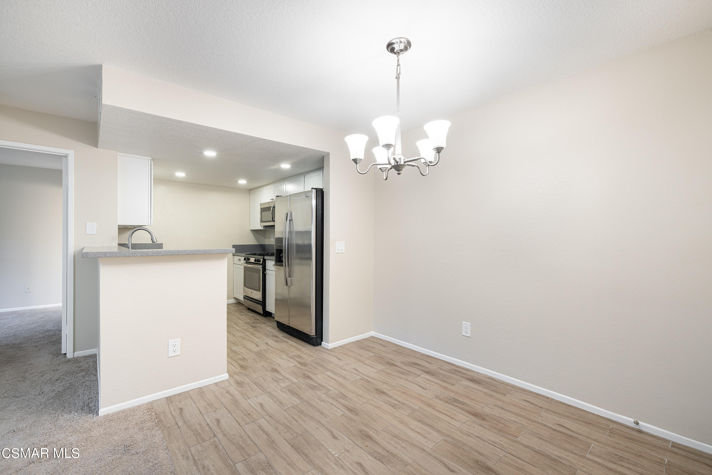 1125 Fitzgerald Road, Unit F Simi Valley, CA 93065 - Photo 13 of 25 a view of a kitchen with a sink wooden floor and a kitchen