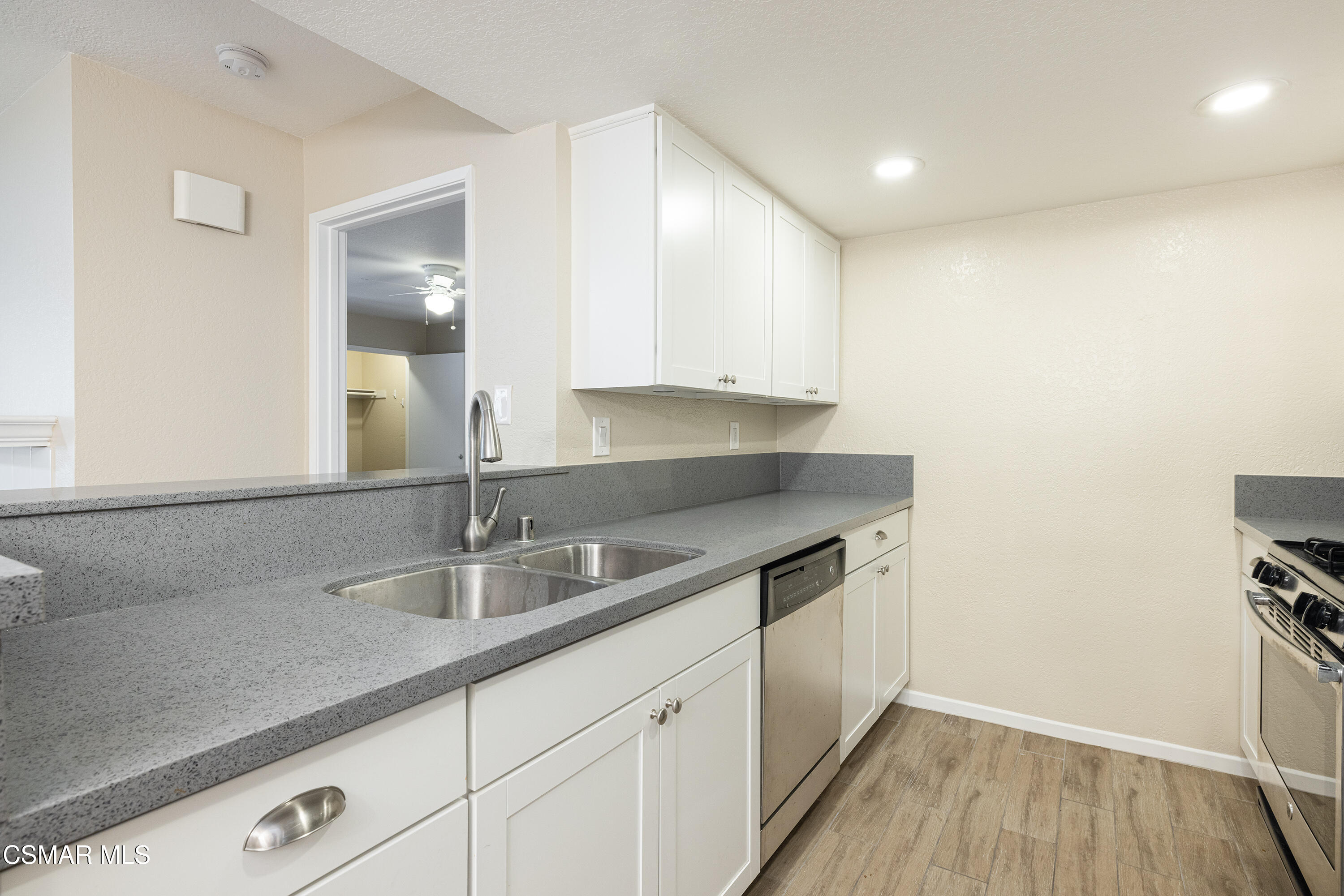 1125 Fitzgerald Road, Unit F Simi Valley, CA 93065 - Photo 15 of 25 a kitchen with a sink and cabinets