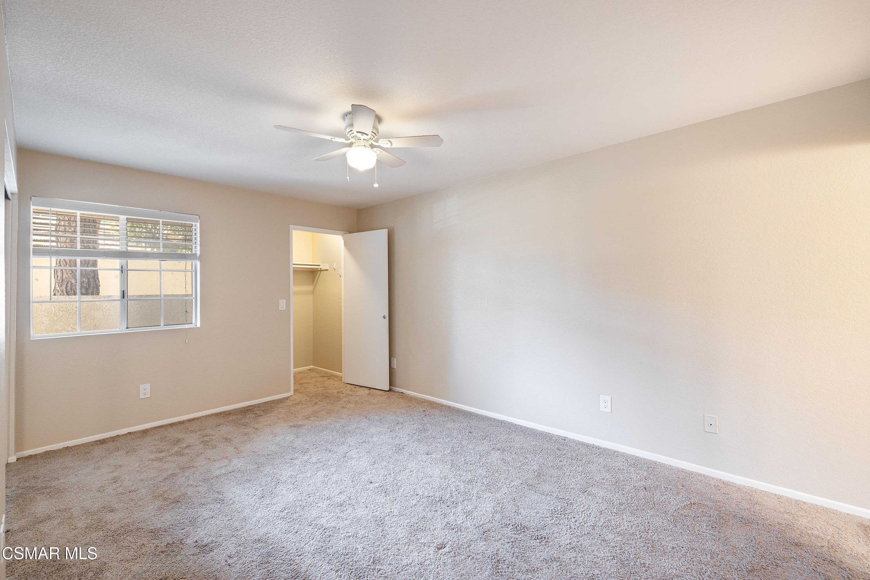 1125 Fitzgerald Road, Unit F Simi Valley, CA 93065 - Photo 17 of 25 an empty room with chandelier fan and windows