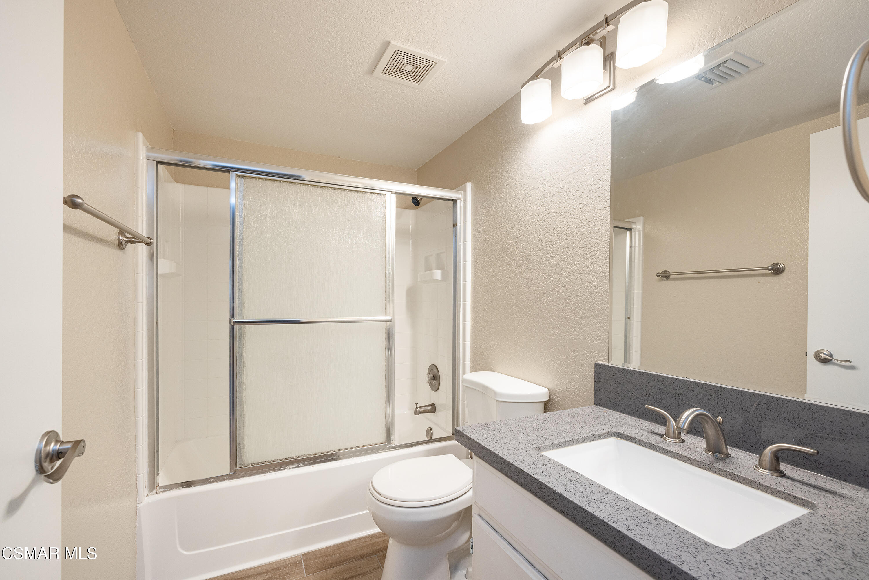 1125 Fitzgerald Road, Unit F Simi Valley, CA 93065 - Photo 20 of 25 a bathroom with a granite countertop sink toilet a mirror and shower