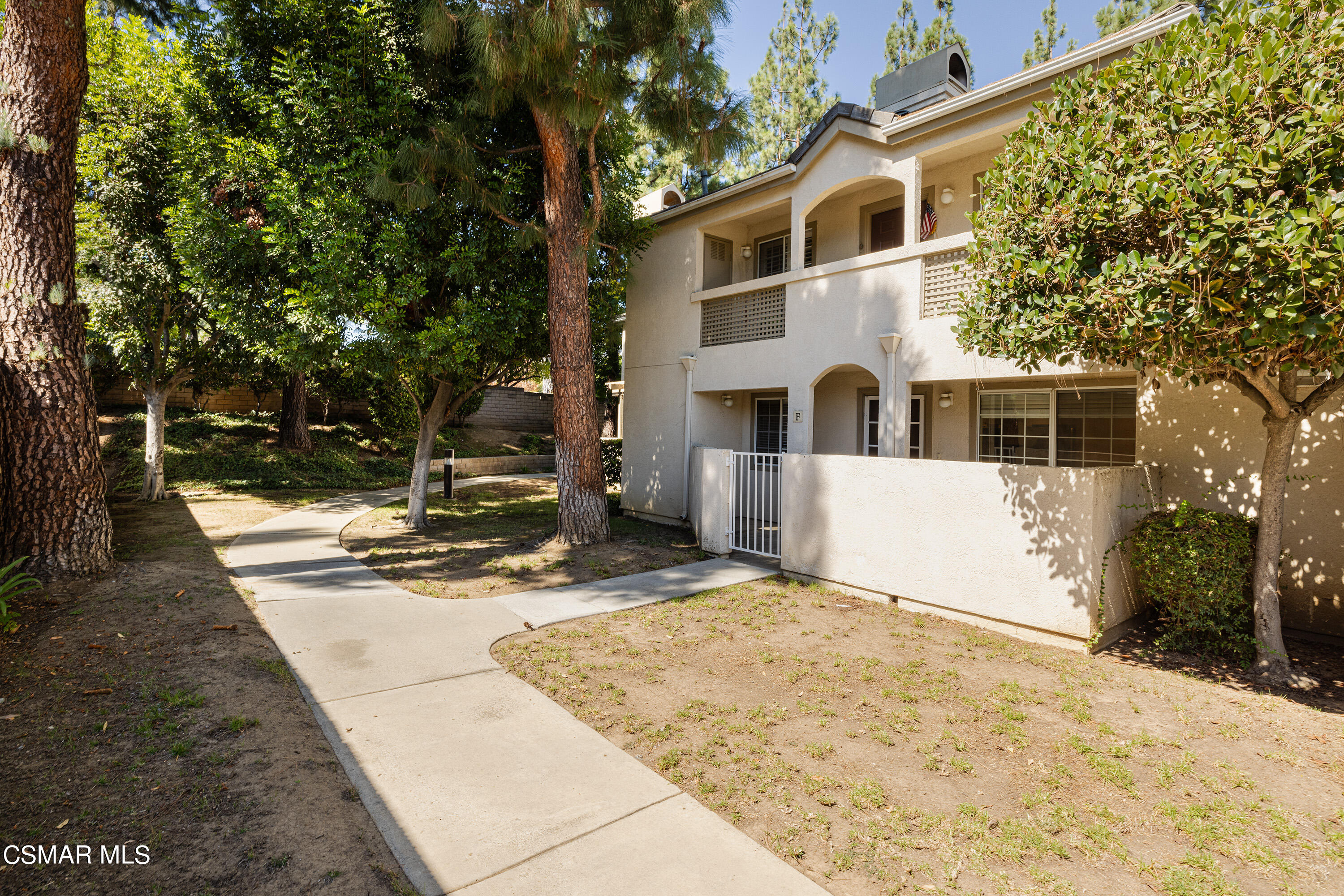 1125 Fitzgerald Road, Unit F Simi Valley, CA 93065 - Photo 2 of 25 a front view of a house with a yard