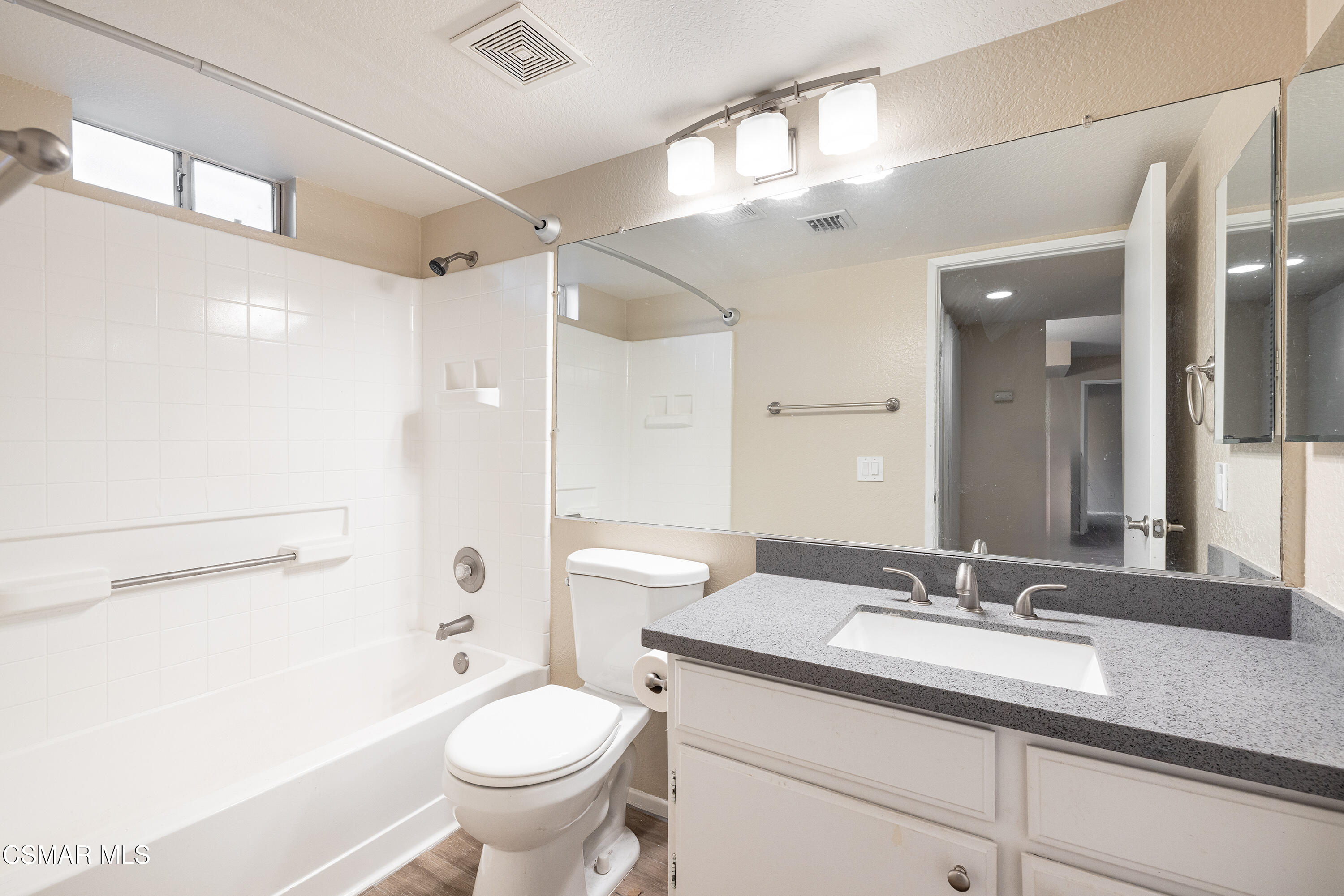 1125 Fitzgerald Road, Unit F Simi Valley, CA 93065 - Photo 23 of 25 a bathroom with a granite countertop sink toilet and shower