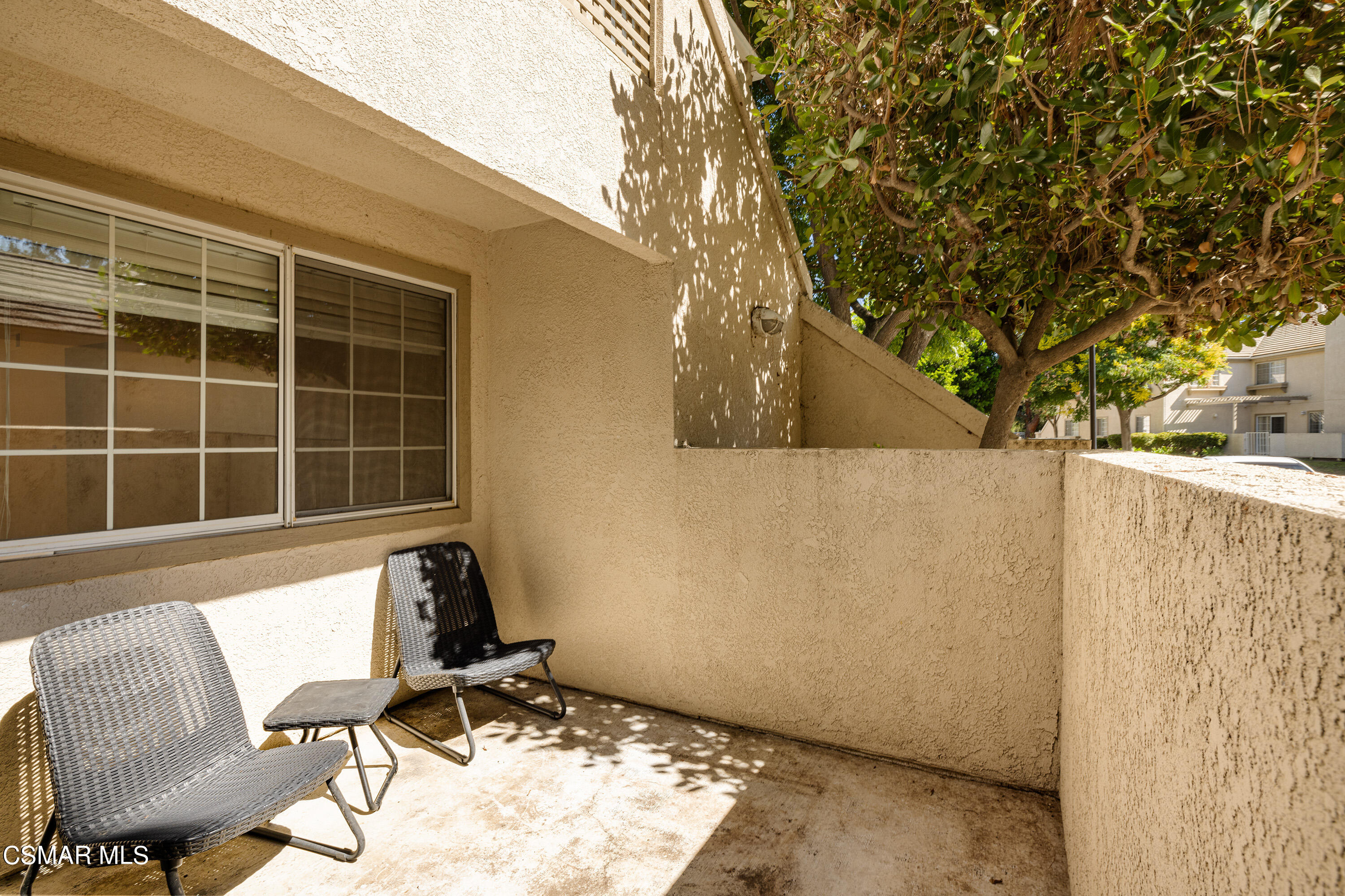 1125 Fitzgerald Road, Unit F Simi Valley, CA 93065 - Photo 5 of 25 a view of a chair and table in the back yard of a building