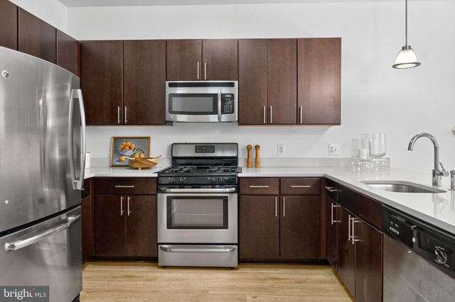 a kitchen with a sink stove and refrigerator