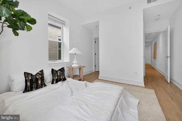 a bed room with a bed and a potted plant