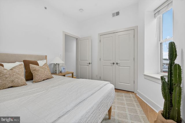 a bedroom with a bed and a mirror