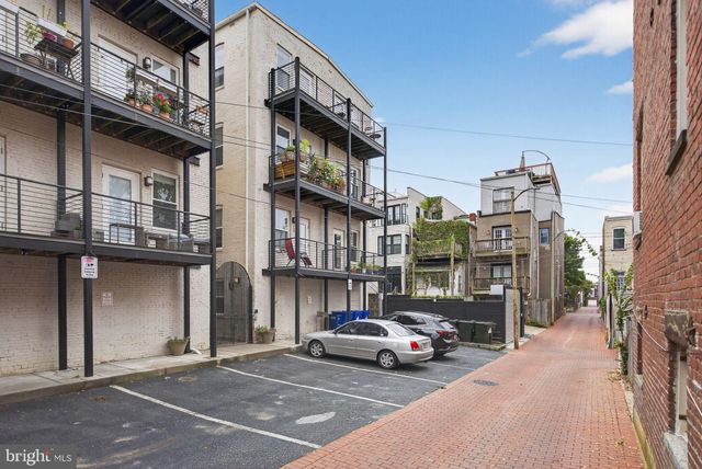 a yellow house with trees in front of it