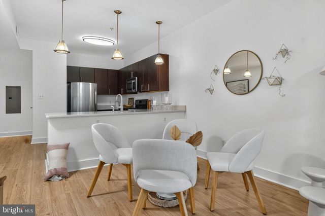 a living room with furniture a mirror and a chandelier