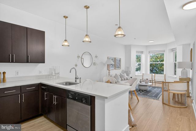 a kitchen with a sink appliances and cabinets