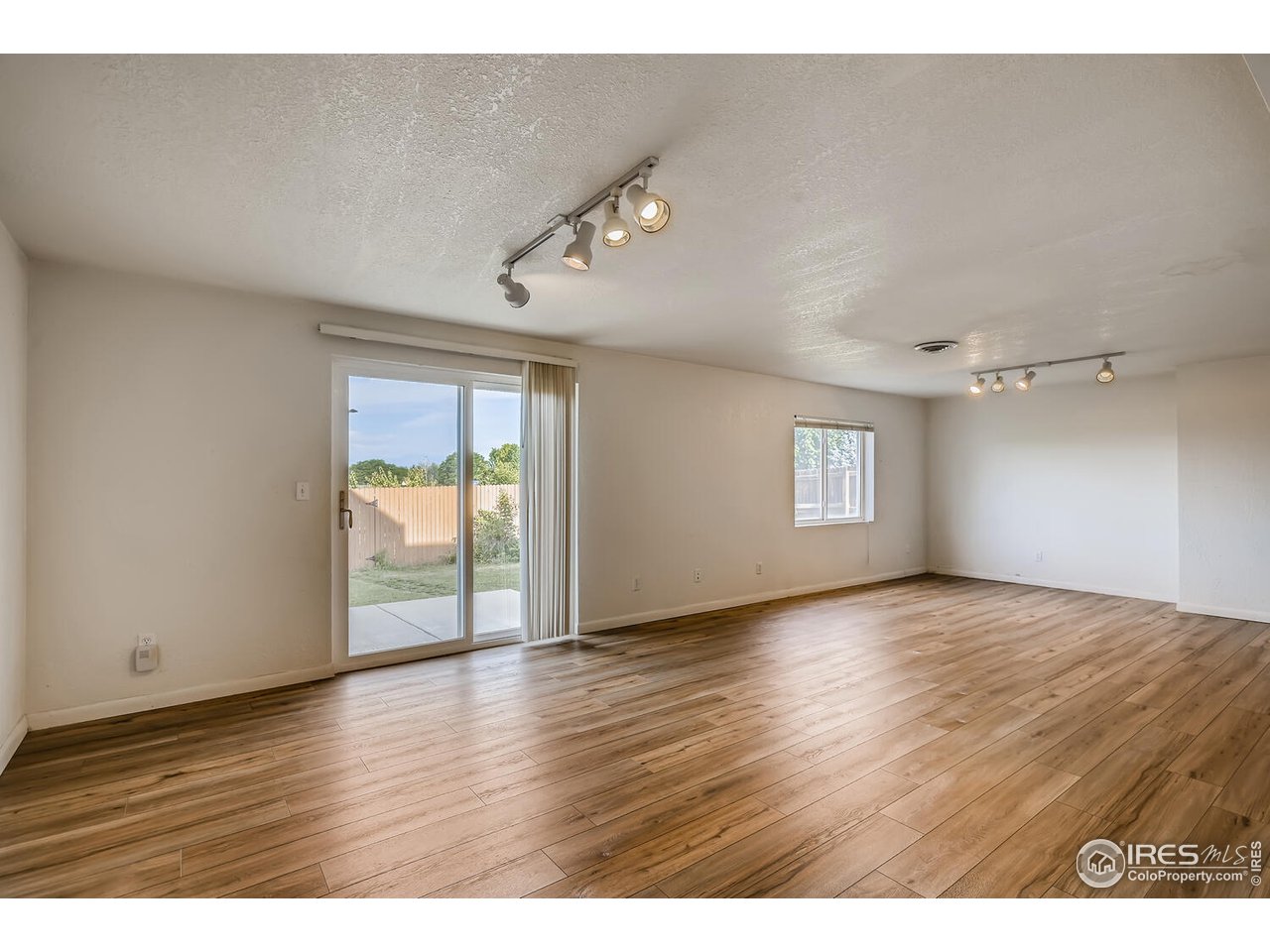 549 Rider Ridge Drive Longmont, CO 80504 - Photo 32 of 38 a view of an empty room with wooden floor and a window