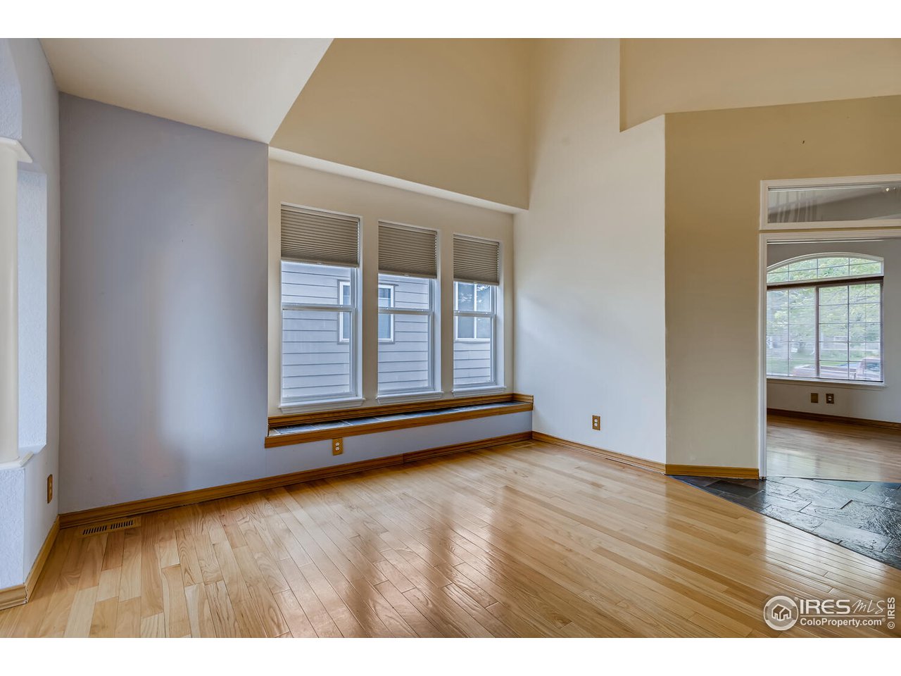 549 Rider Ridge Drive Longmont, CO 80504 - Photo 5 of 38 a view of an empty room with wooden floor and a window