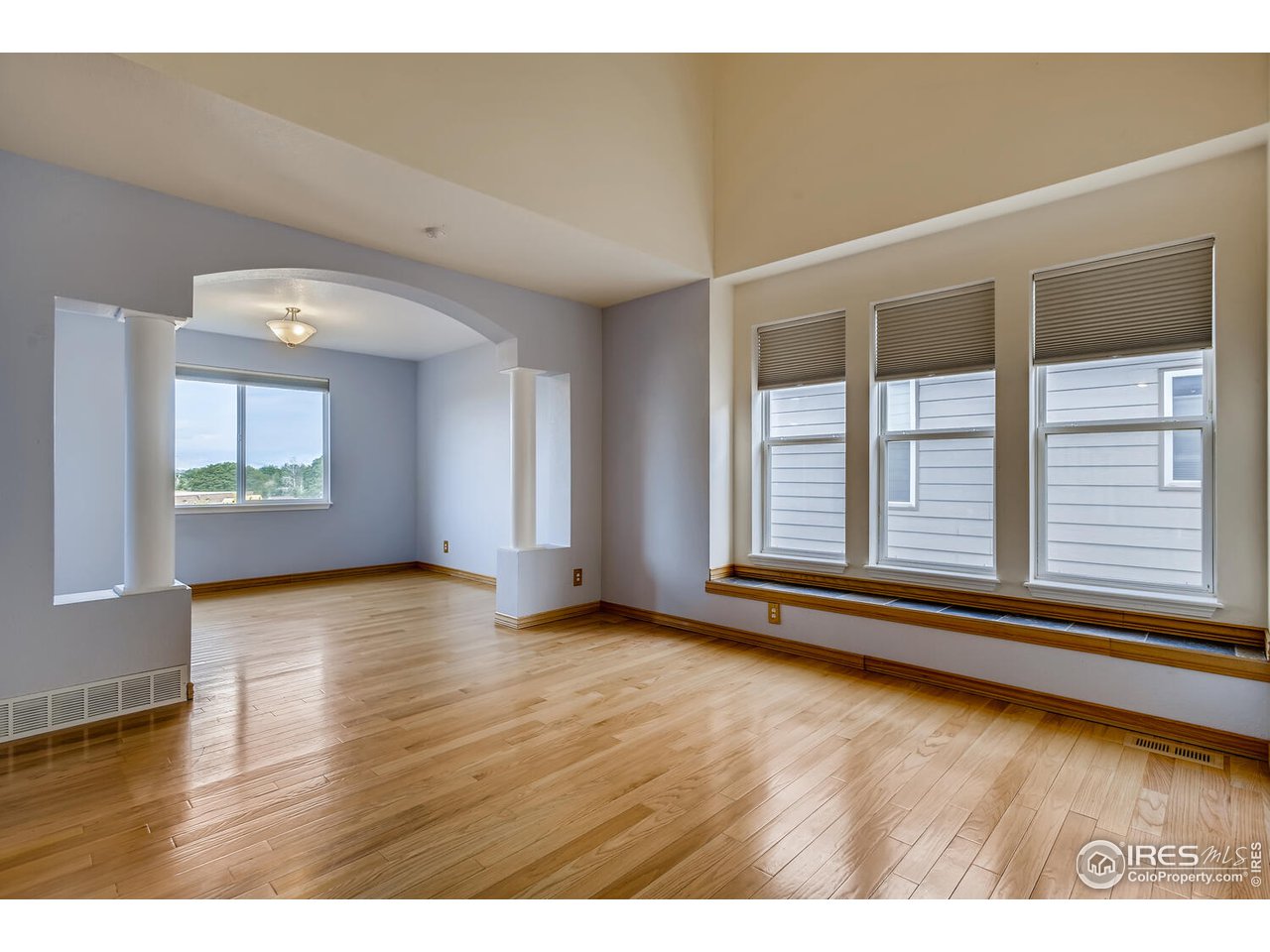 549 Rider Ridge Drive Longmont, CO 80504 - Photo 6 of 38 a view of an empty room with wooden floor and a window
