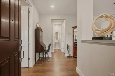 a view of a hallway with furniture and staircase