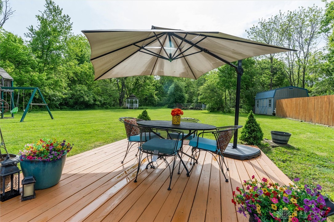 2165 Stewart Road Xenia, OH 45385 - Photo 51 of 59 Enjoy outdoor living on this expansive wooden deck, overlooking a verdant lawn.