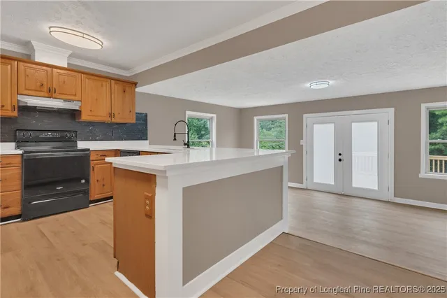a kitchen with stainless steel appliances granite countertop a stove and a refrigerator
