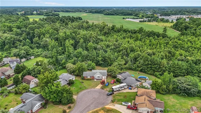 an aerial view of a house with a yard and lake view