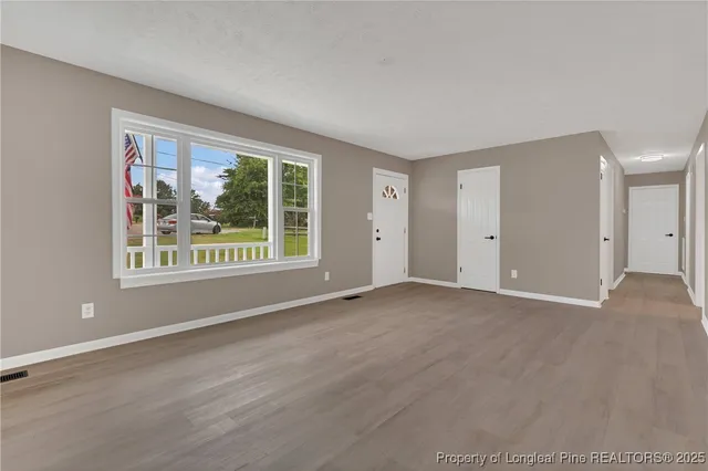 a view of an empty room with a window