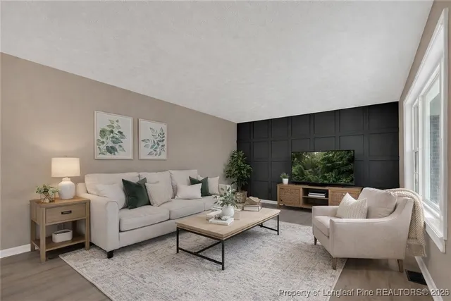 a living room with furniture and a potted plant