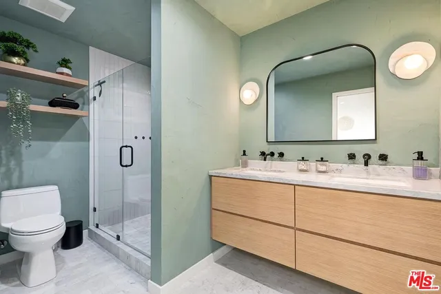 a bathroom with a sink mirror vanity and toilet