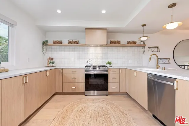 a kitchen with a sink stove and cabinets