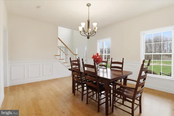 a living room with furniture and a view of kitchen
