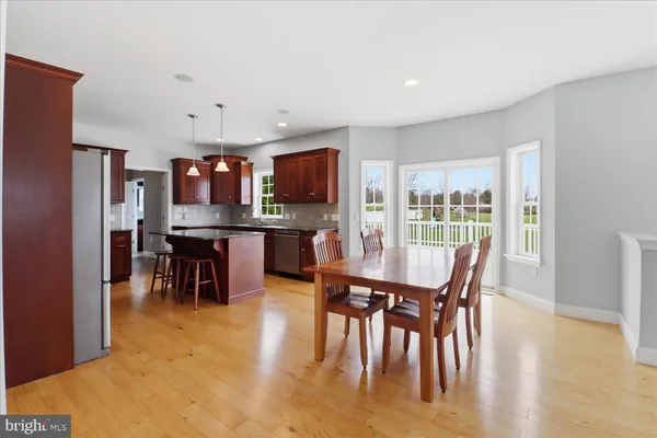 a living room with furniture kitchen view and a window