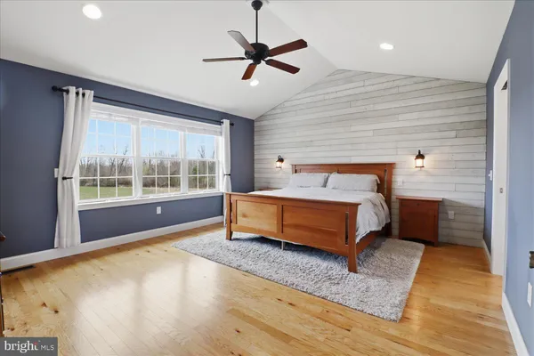 a spacious bedroom with a bed and a window