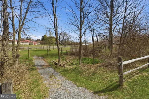 a view of a house with a yard and pathway