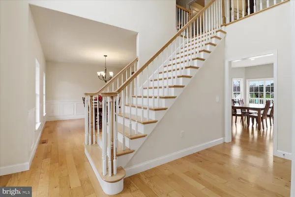 a view of a hallway with wooden floor and closet