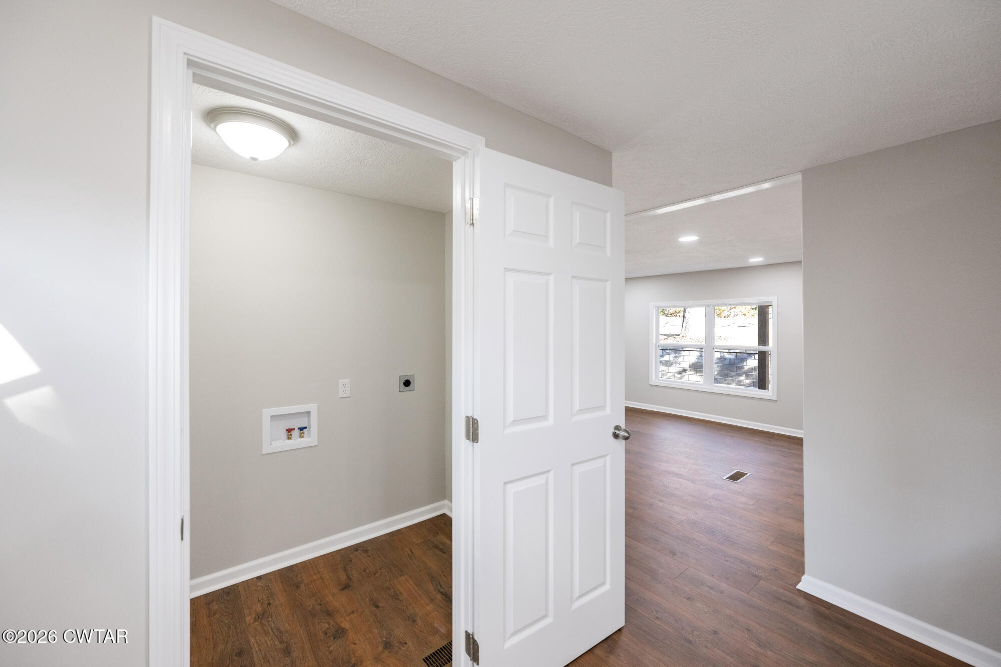 992 Greenway Road Huron, TN 38345 - Photo 11 of 17 an empty room with wooden floor and windows