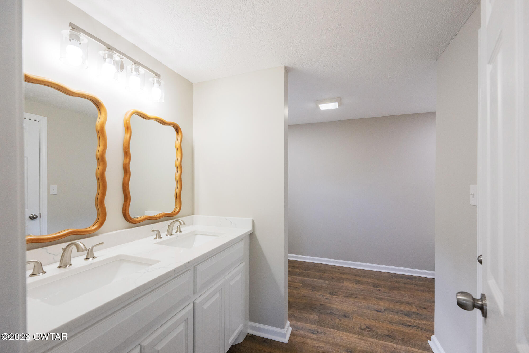 992 Greenway Road Huron, TN 38345 - Photo 13 of 17 a bathroom with a double vanity sink and mirror