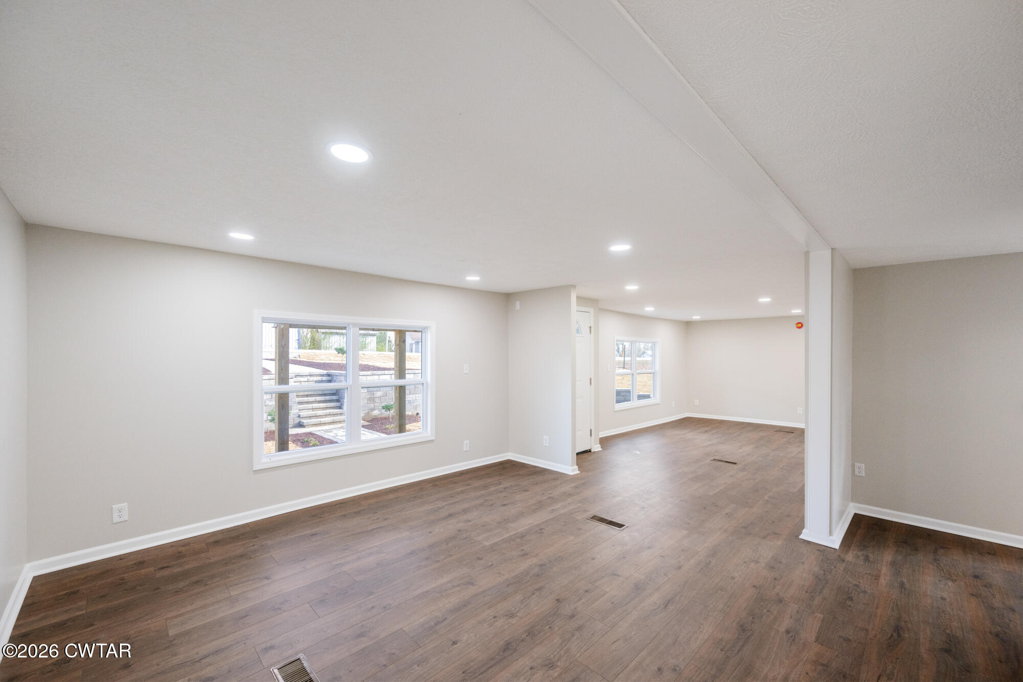 992 Greenway Road Huron, TN 38345 - Photo 9 of 17 an empty room with wooden floor and windows