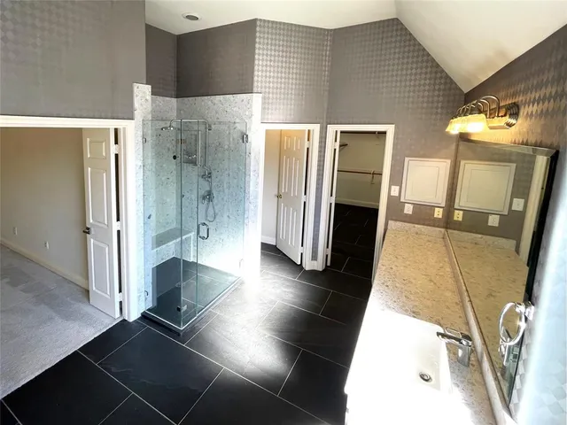 a bathroom with a double vanity sink and a mirror