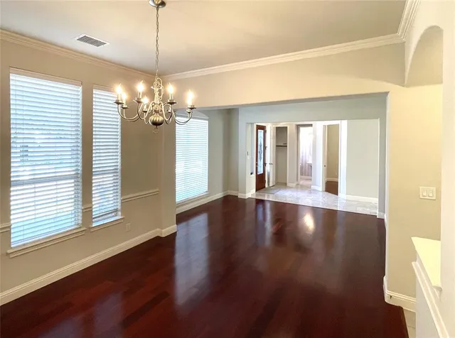 a view of a room with window and wooden floor