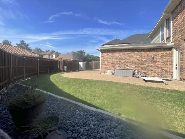 a view of a backyard with floor to ceiling window