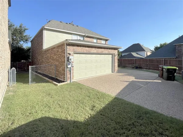 a view of a house with a yard and garage