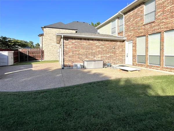 a view of a house with a yard and a large parking space
