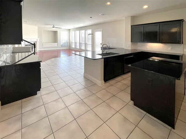 a kitchen with granite countertop a sink and a stove