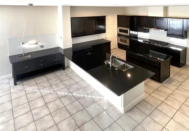 a living room with a bed and a flat screen tv