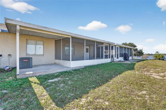 a view of a house with backyard and porch