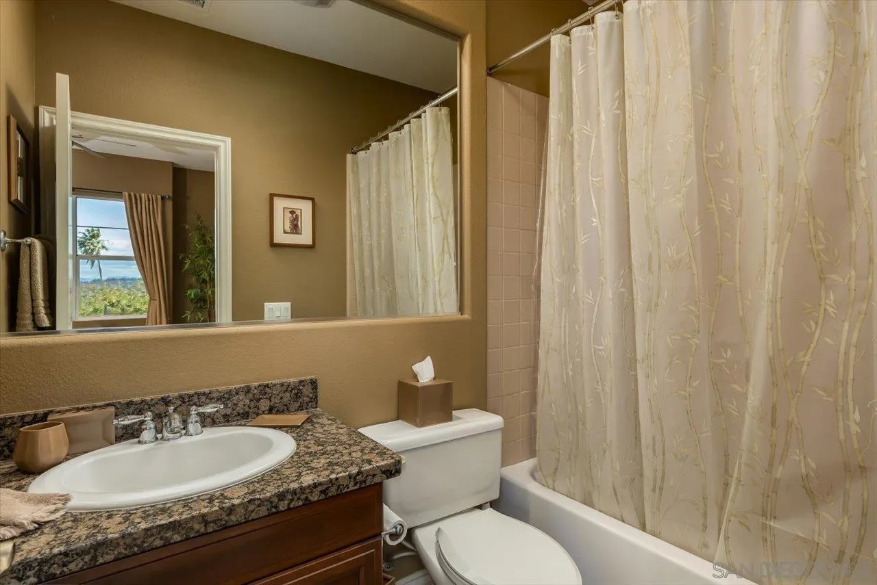 1505 Chateau Lafite Bonsall, CA 92003 - Photo 19 of 47 a bathroom with a granite countertop sink and a mirror