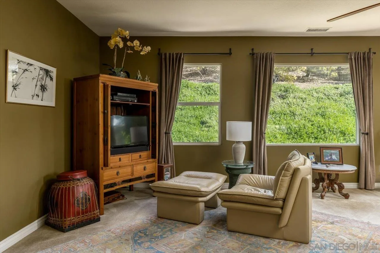 1505 Chateau Lafite Bonsall, CA 92003 - Photo 21 of 47 a living room with furniture and a flat screen tv