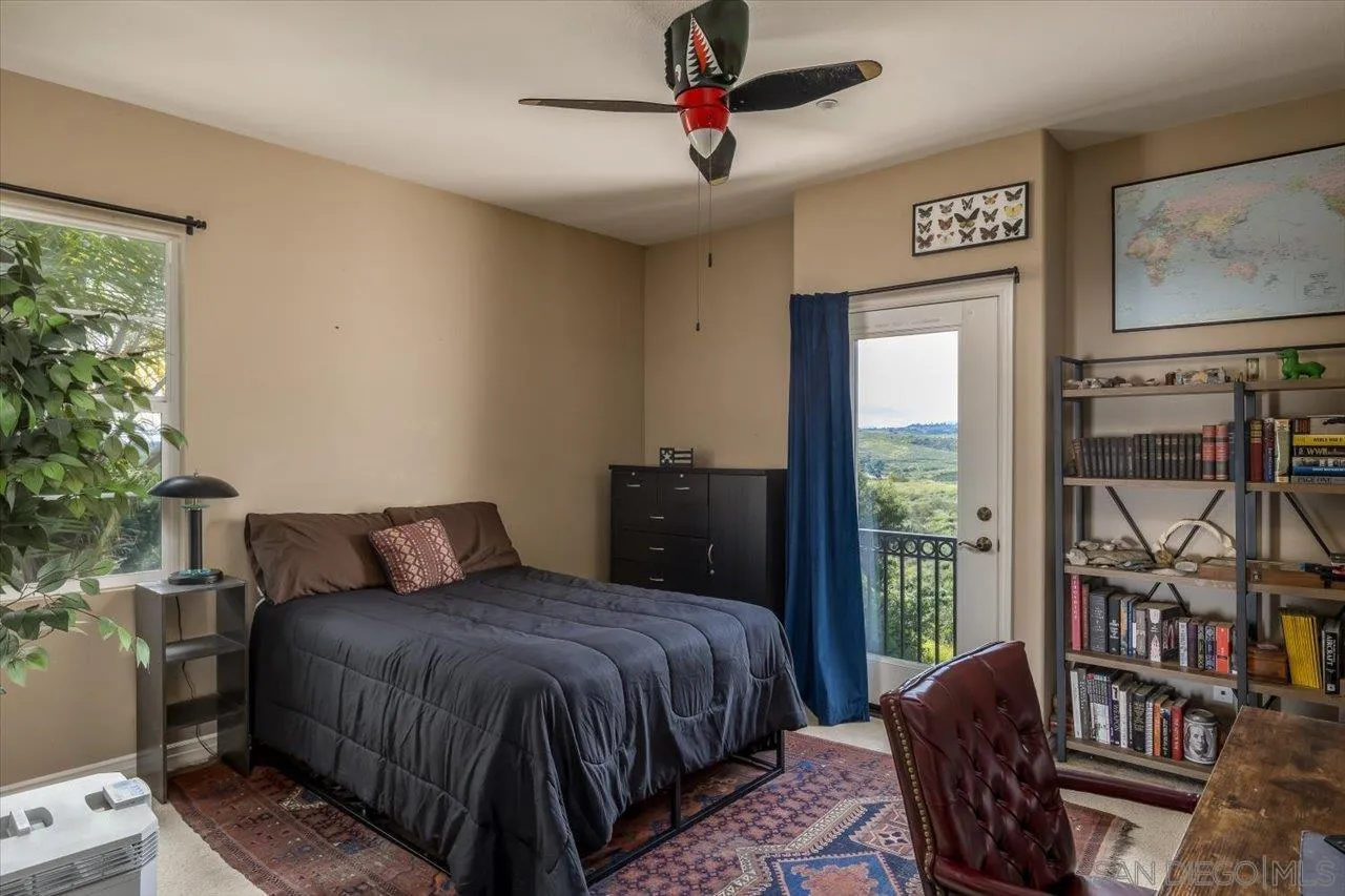 1505 Chateau Lafite Bonsall, CA 92003 - Photo 25 of 47 a bedroom with a bed a couch and a window